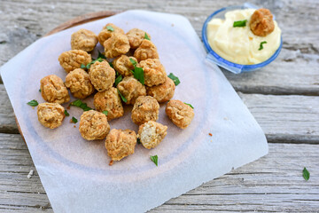 Crispy  deep fried   chicken  nuggets . Breaded  with Cornflakes Breast fillets  with chilly peppers and fresh   basil on wooden rustic background