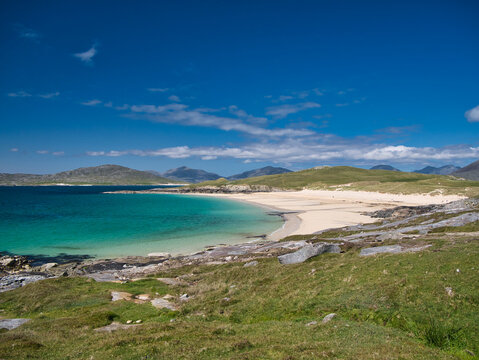The white sands and turquoise waters of the pristine Luskentyre Bay in the Outer Hebrides. Taken on a sunny day in summer.