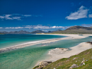 The white sands and turquoise waters of the pristine Luskentyre Bay in the Outer Hebrides. Taken on a sunny day in summer.