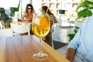 drinking cocktail in a bar restaurant in Porto Portugal with blurry people in the background