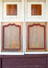 The closed wooden window of the ticket booth.