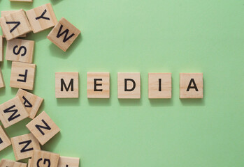 Text media on wooden cubes on green background