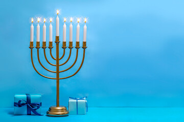 Jewish Hanukkah Menorah 9 Branch Candlestick, gift box. Holiday Candle Holder. Nine-arm candlestick. Traditional Hebrew Festival of Lights candelabra. Background for design with copy space