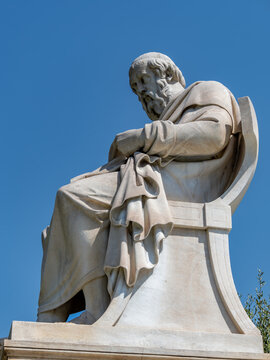 Plato marble statue, the ancient Greek philosopher, isolated on plain sky background. Travel to Athens, Greece.
