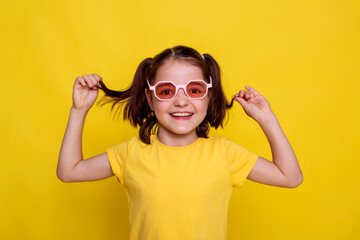 child girl in yellow T-shirt with hairstyle two ponytails on yellow background enjoy seasonal sale...