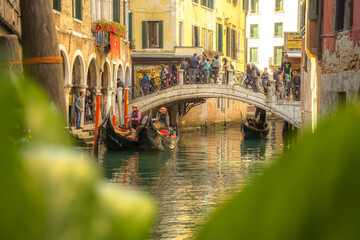 Fototapeta na wymiar Venetian Canal Panorama: Gondola and Iconic Bridge in Venice, Italy