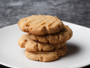 Homemade peanut butter cookies stacked on a plate