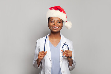 Smiling young doctor in Santa hat, Christmas portrait