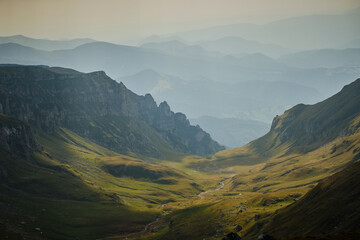 Beautiful mountain terrain in Bucegi National Park  Mountain landscape with green meadow and sharp rocks.