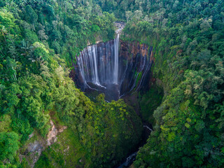 Aerial top view from above of Tumpak Sewu ,also known as Coban Sewu, 120m high waterfall in Malang regency, East Java, Indonesia - 641817298