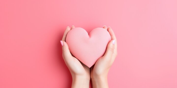 Young women hands holding paper pink heart on pink background, health care, donate and family insurance concept, world heart day, world health day, Valentine's day, generative ai