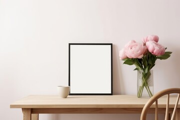 Living room, indoor still life. Empty picture frame mockup on beige wall. Wooden table and old chair. Glass vase with pink peonies bouquet. Elegant working space, home office concept. Generative AI - obrazy, fototapety, plakaty