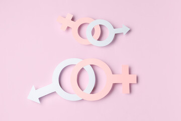 Paper symbols of male and female on lilac background