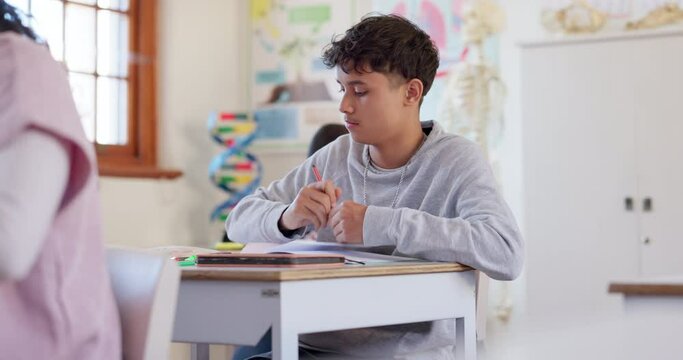 School, exam and a boy student writing in class during a test or assessment learning or development. Education, kids and a male child at a classroom desk for academic study or scholarship assignment