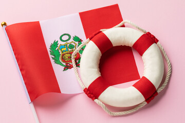 Peruvian flag and lifebuoy on a blue background, concept on the theme of helping Peru