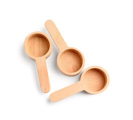 Empty wooden scoops on white background