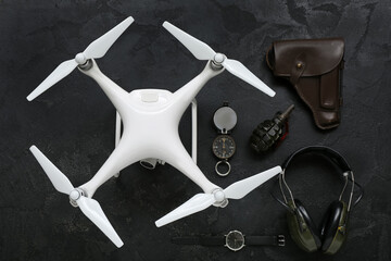 Modern quadcopter and military set on black background