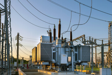 High voltage transformer in the rays of the morning sun. the result of shooting in the direction of sunrise.