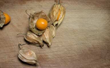 Fresh Aguaimanto fruit from Peru, with the original leaves on a wooden table.