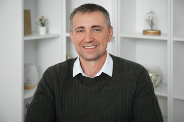 Portrait of happy mature man in room