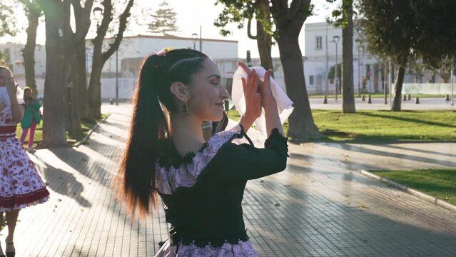 portrait young latin woman clapping to the rhythm of the cueca dressed as a huaso