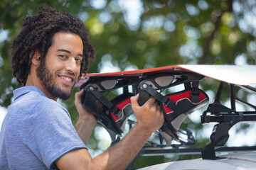 Naklejka premium a man puts prepares a roof rack