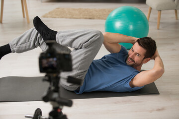 male sport blogger recording video at home