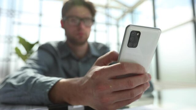 businessman professional executive holding mobile working at desk with smartphone.