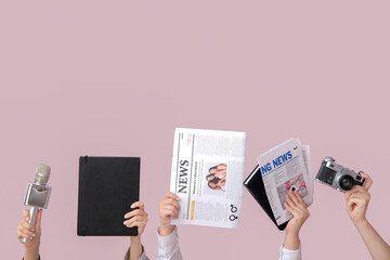 Female hands with newspapers, notebooks, microphone and photo camera on color background