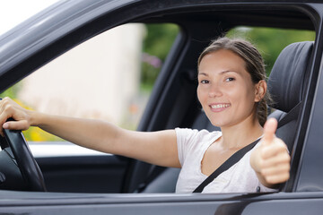 female driver showing thumbs up