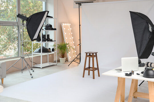 Interior of photo studio with equipment and stool
