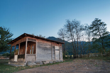 Old wooden hut with evening blue sky background