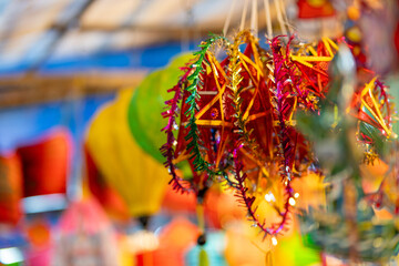 Decorated colorful lanterns hanging on a stand in the streets in Ho Chi Minh City, Vietnam during Mid Autumn Festival. Chinese language in photos mean money and happiness