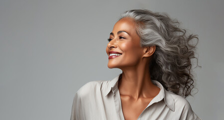 Beautiful black woman with smooth healthy face skin. Gorgeous aging mature woman with long gray hair and happy smiling. Beauty and cosmetics skincare advertising concept. - 641851880