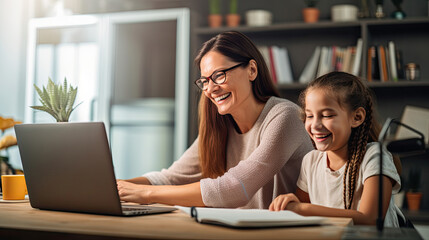 Girl and mother laughing while doing homework.