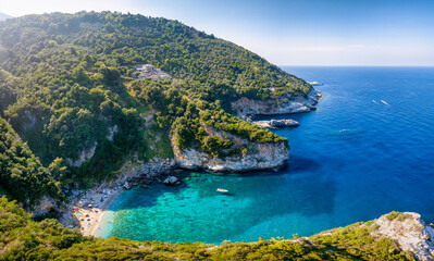 The remote beach of Fakistra, North Pelion mountain, Greece, with emerald shining sea and thick pine forest