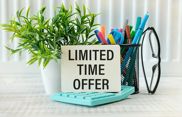 Business concept. There are three notebooks on the work table near a plant in a pot with text-limited time offer