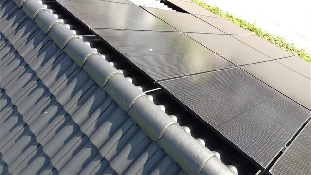 Drone movement over roof of a villa with solar panels