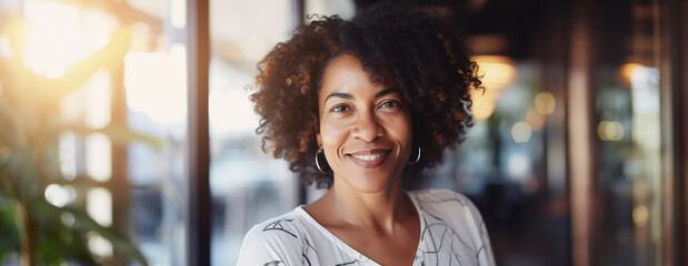 Headshot portrait of professional black woman entrepreneur in modern interior