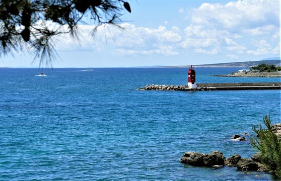 Red lighthouse and sea horizon