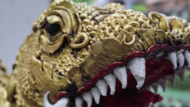head of a statue of a golden snake in chiang mai, thailand
