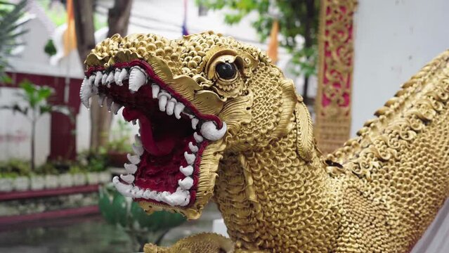 statue of a golden snake in chiang mai, thailand