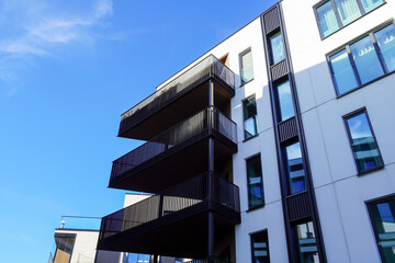 Look up to white appartment building with balconies towards blue sky. Kalamaja, Tallinn, Estonia