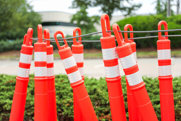 construction cone on the road signifies ongoing progress, caution, and temporary disruption in the...