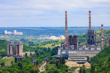 Plant or factory. Industrial area in a picturesque beautiful green area. Background with selective focus and copy space