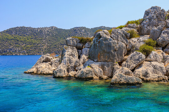 View of the rocky shore from the sea. Mediterranean Sea in Turkey. Popular tourist places. Background