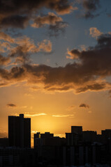 Fototapeta na wymiar Sunset Over a Cityscape Silhouette.