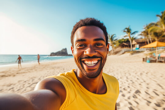 Happy young african american man enjoying a day on the beach while smiling and making a picture