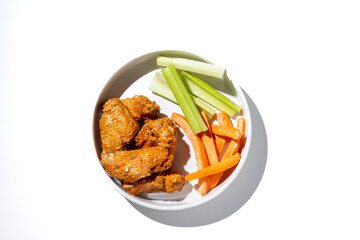 Chicken Wing Dinner with Carrots and Celery Side on Solid White Background