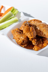 Chicken Wing Dinner with Carrots and Celery Side on Solid White Background